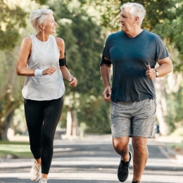 older man and woman jogging outside
